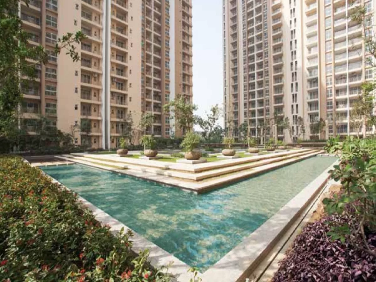 Clubhouse outdoor resort-style pool with wooden deck at Cocoa County Sector 88A Gurgaon